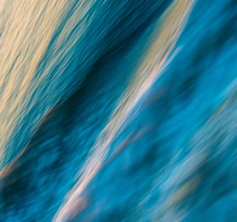 The image shows an abstract, blurred background with swirling strokes of blue and white, creating a dynamic and mesmerizing visual effect