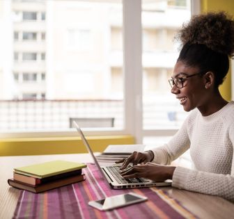 A woman at home working on a laptop.