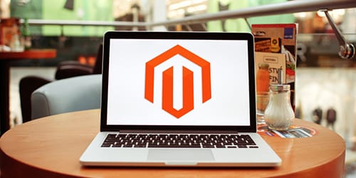A laptop with a Magento logo on it