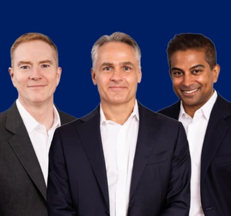 The image shows a portrait of three professional-looking men in suits, all smiling, against a blue background. The image is named "BR KB And DP (1)", suggesting the names of the individuals