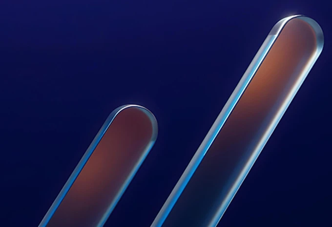 The image shows two elongated, reflective metal bars against a deep blue background, creating an abstract, futuristic composition