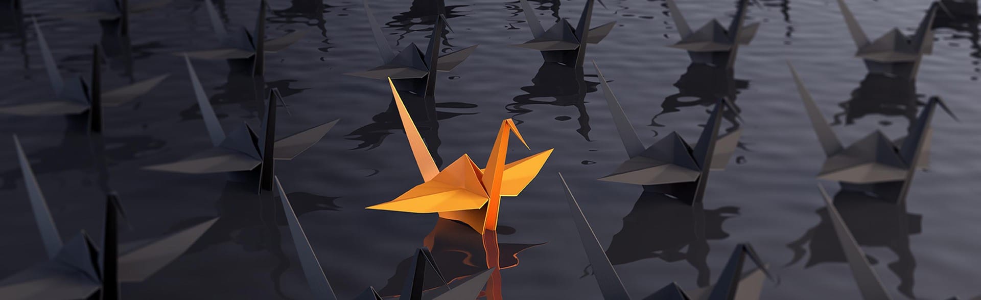 An orange origami swan floating in the ocean