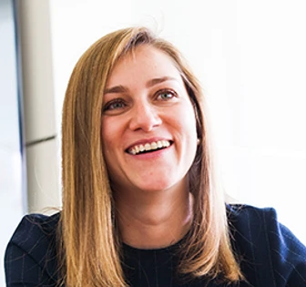 The image shows a smiling woman with long, blonde hair wearing a black top. The woman appears to be Ariadna Stefanescu based on the filename