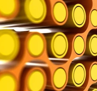 This image depicts a stack of yellow cylindrical objects, likely batteries or similar cylindrical containers, arranged in an organized pattern