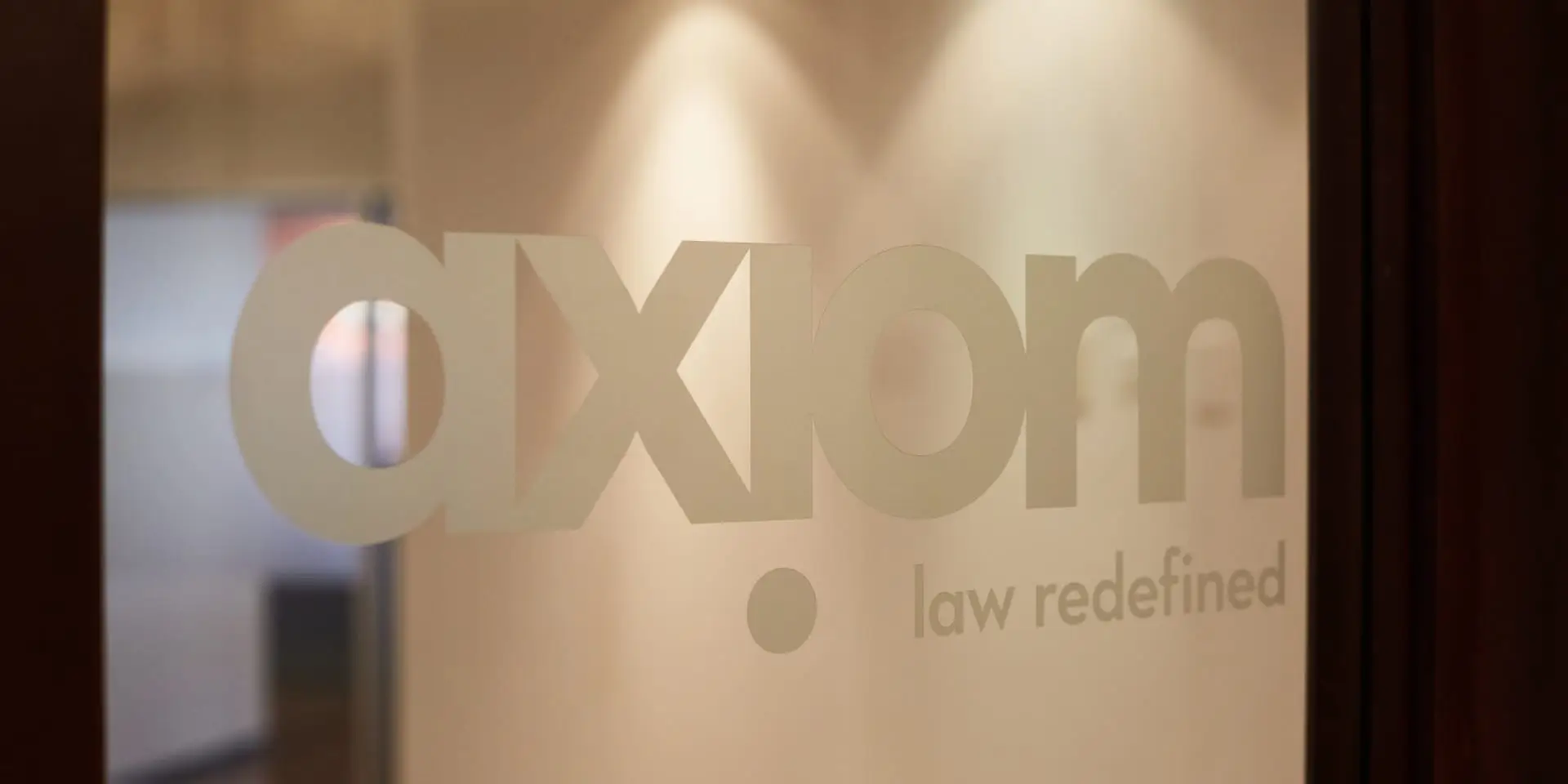 Axiom logo engraved in a glass door.